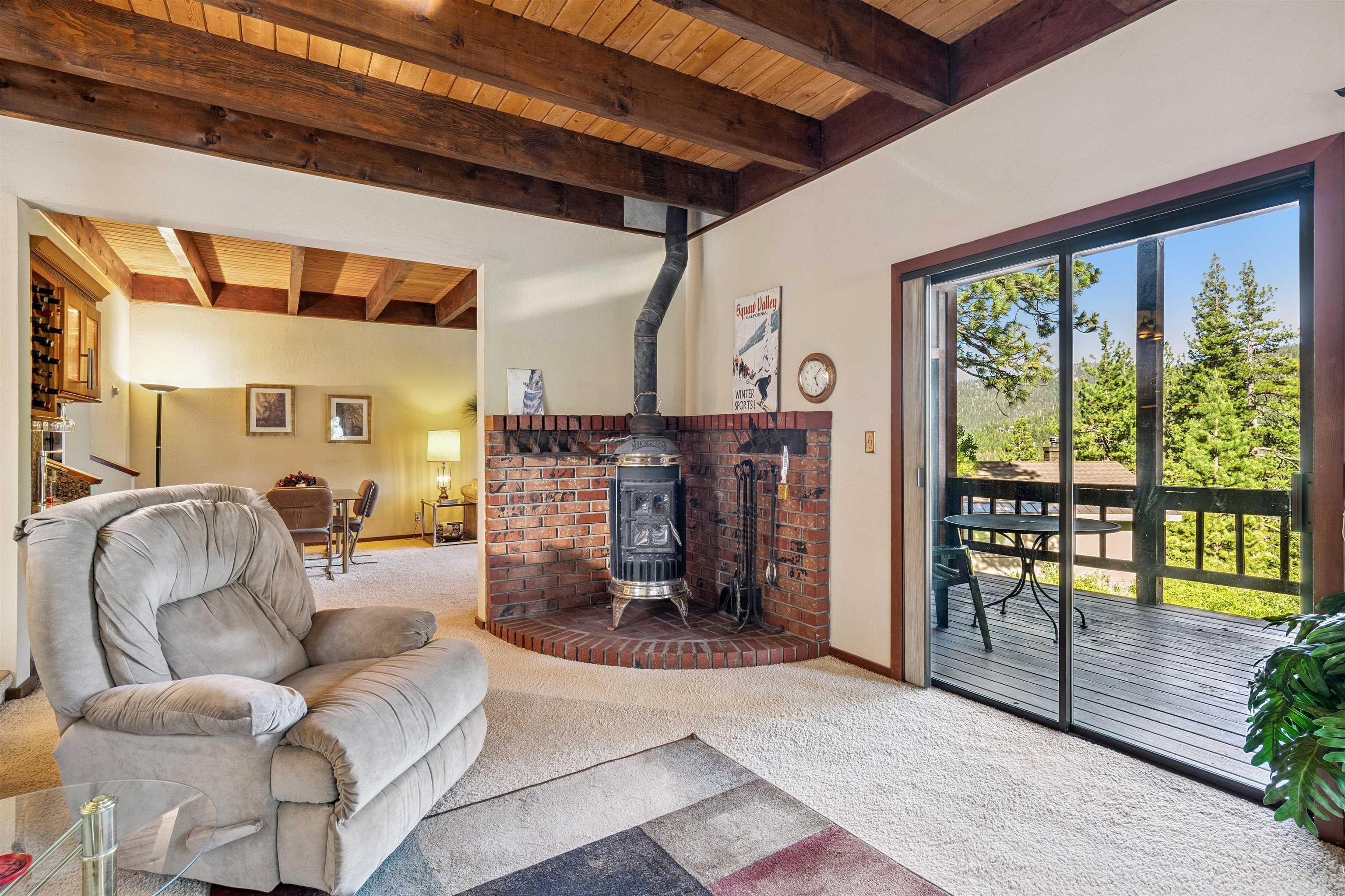 1449 Sandy Way Olympic Valley, CA 96146 - Photo 15 of 27 a living room with fireplace furniture and a floor to ceiling window