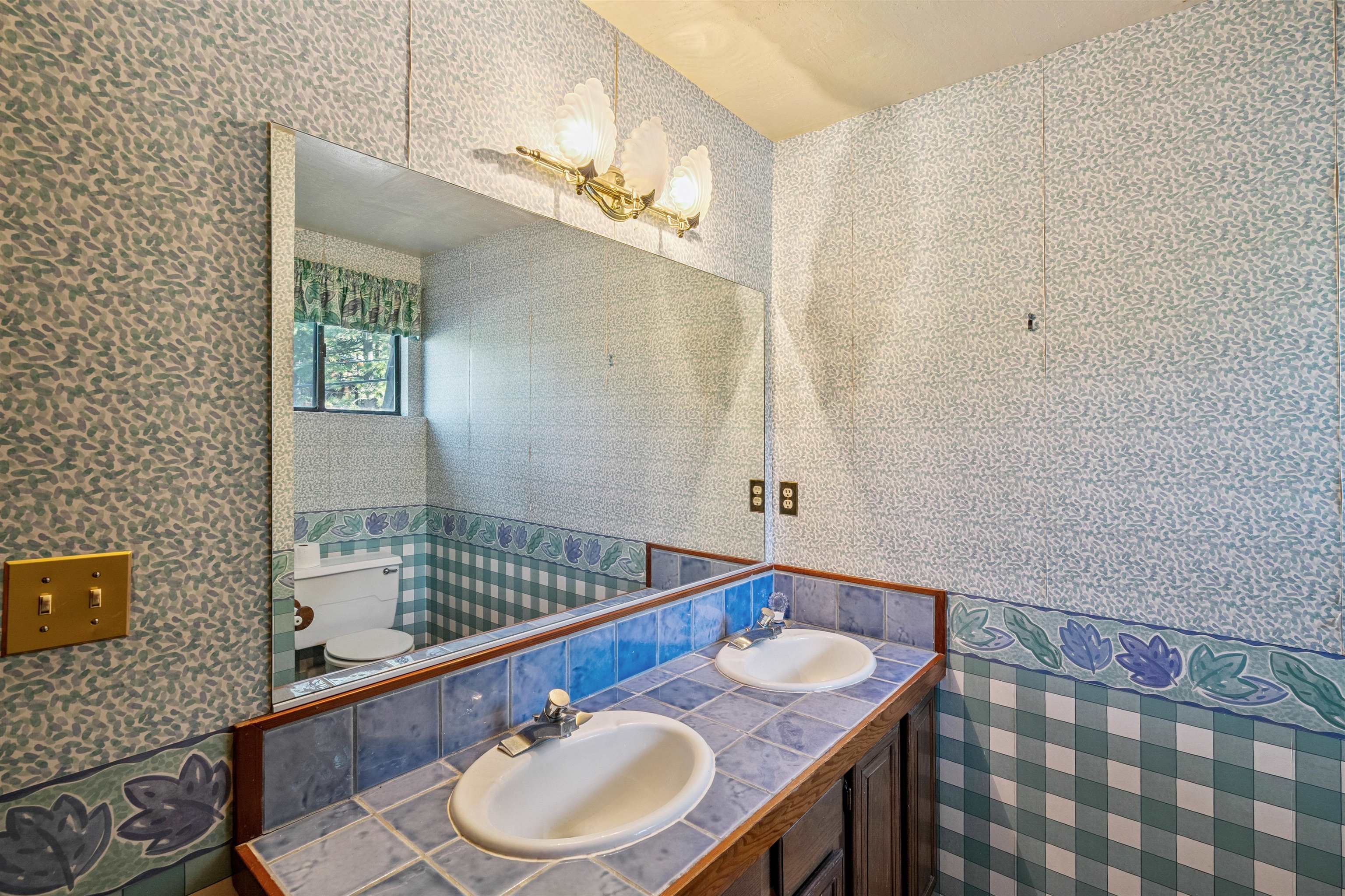 1449 Sandy Way Olympic Valley, CA 96146 - Photo 25 of 27 a bathroom with a sink a mirror and a shower