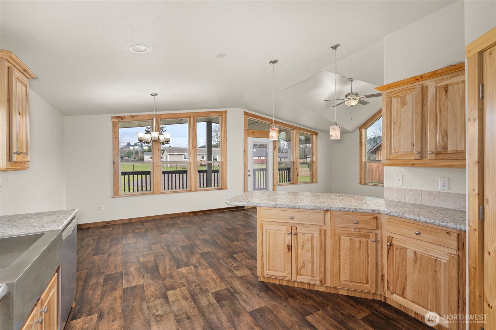 210 Mossyrock Road West Mossyrock, WA 98564 - Photo 20 of 38 a open kitchen with granite countertop a sink and dishwasher with wooden floor