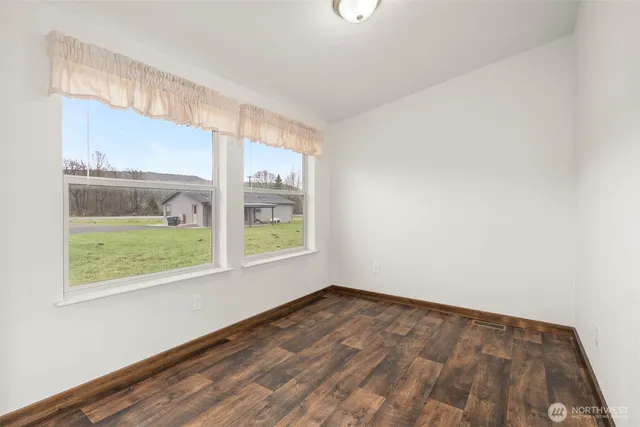 a bathroom with a granite countertop toilet sink and mirror
