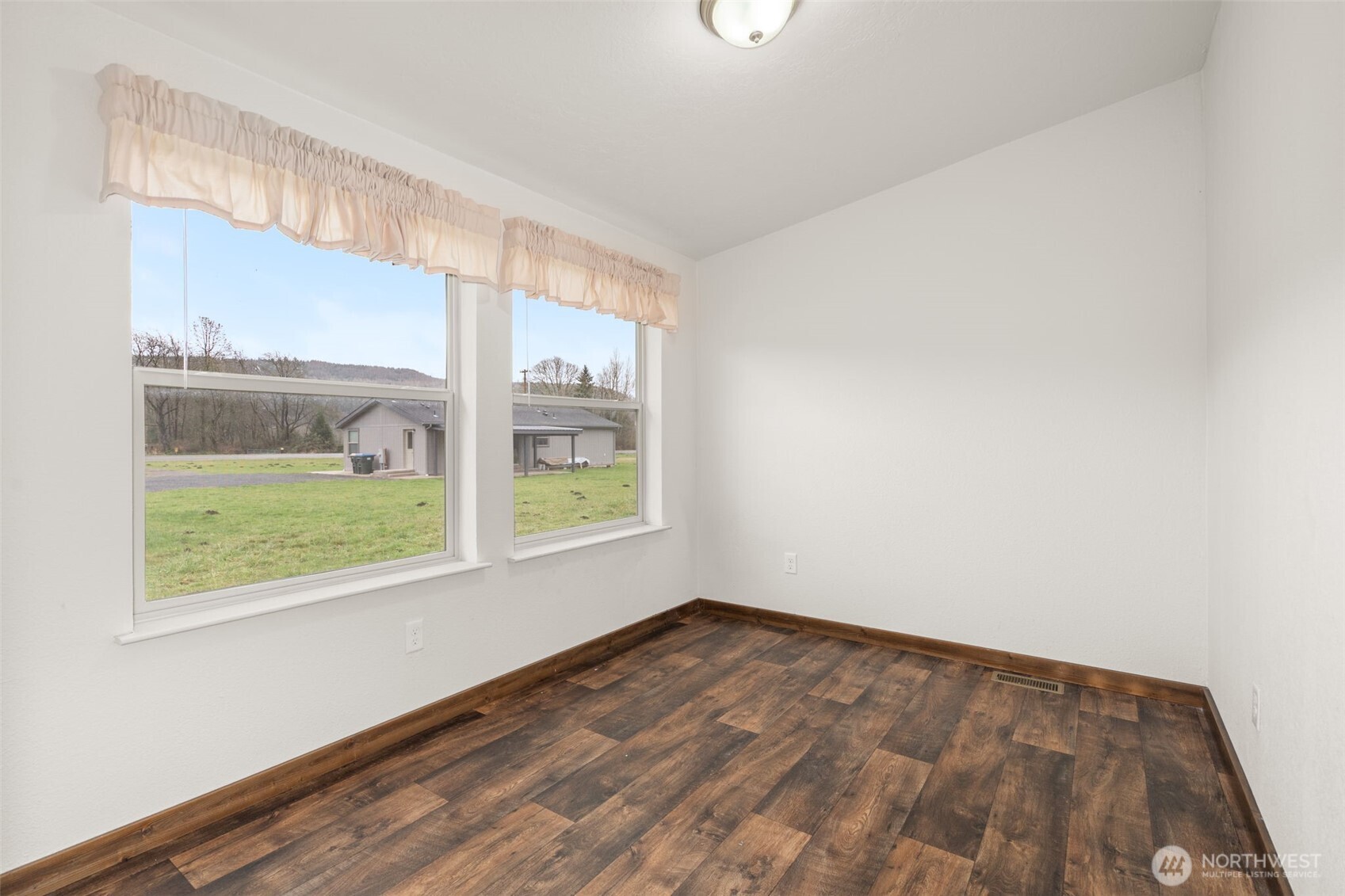 210 Mossyrock Road West Mossyrock, WA 98564 - Photo 27 of 38 an empty room with wooden floor and windows