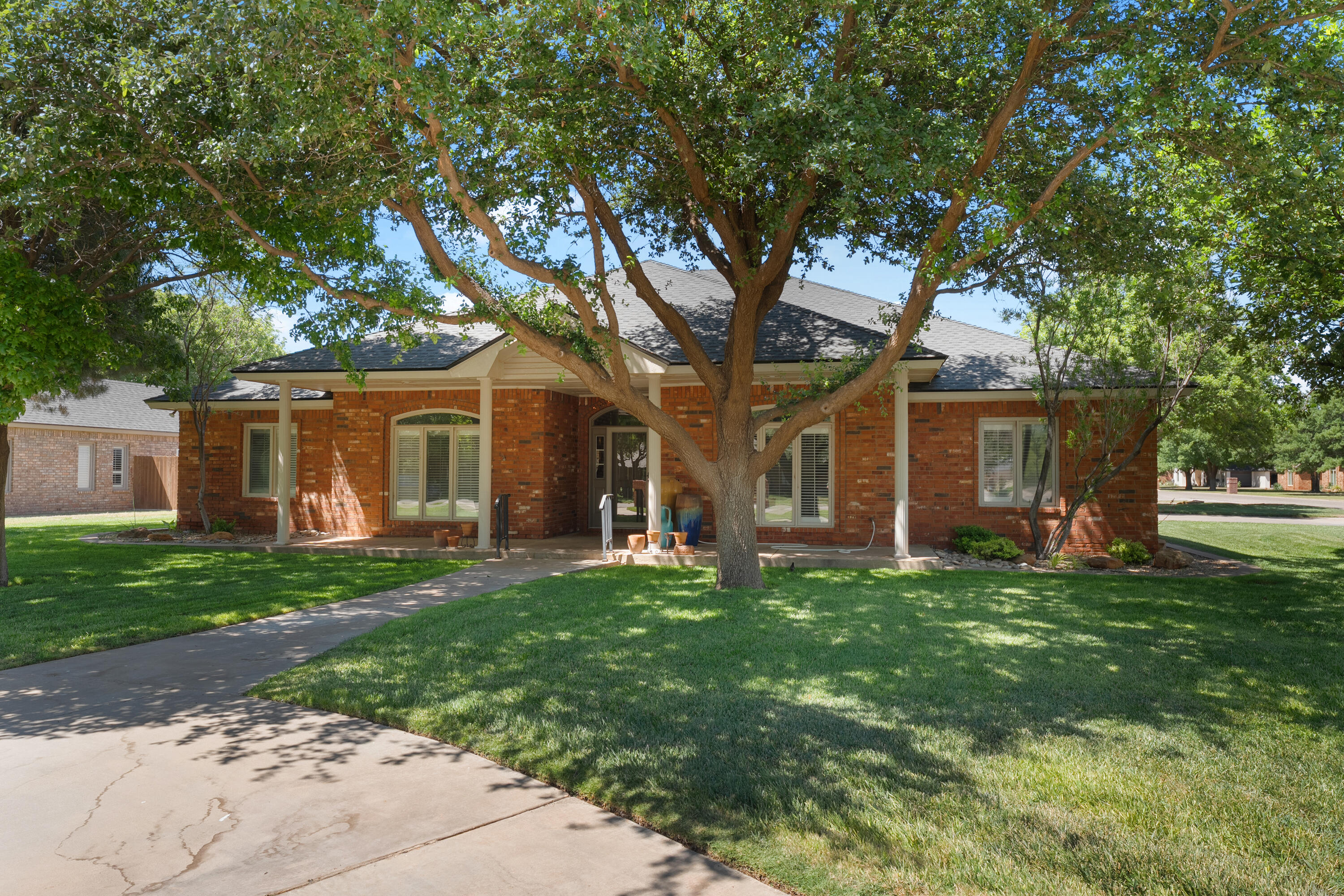 7402 95th Street Lubbock, TX 79424 - Photo 3 of 43 a front view of a house with a garden