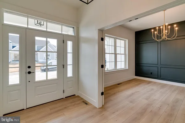 a view of an empty room with glass door and windows