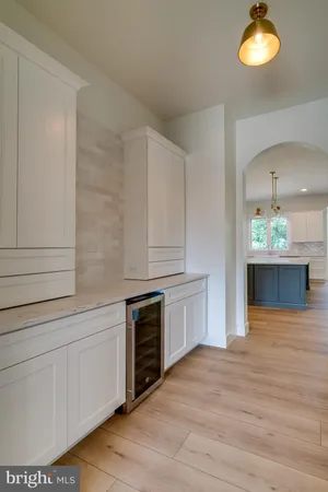 a kitchen with stainless steel appliances granite countertop a white cabinets and stove top oven