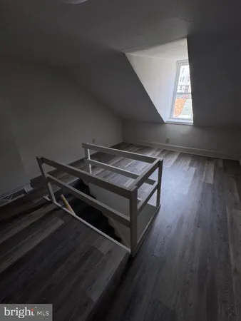 a sitting area with wooden floor