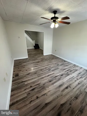 a view of a ceiling fan and wooden floor