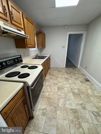 a kitchen that has a sink and a stove