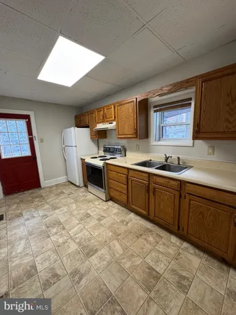 a kitchen with a cabinets and a stove top oven
