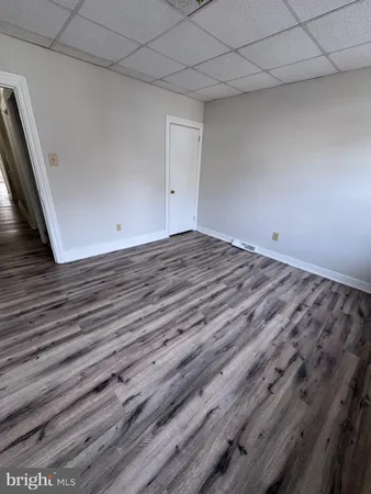 a view of a room with wooden floor