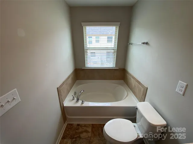 a bath room with a toilet and a sink