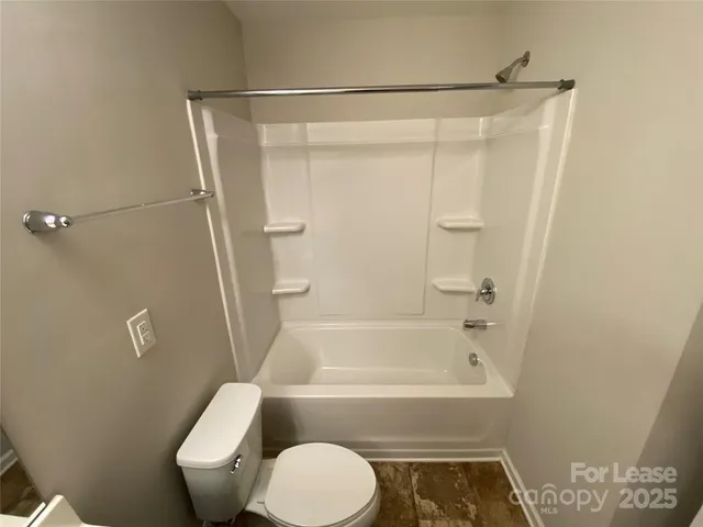 a bathroom with a shower and a toilet
