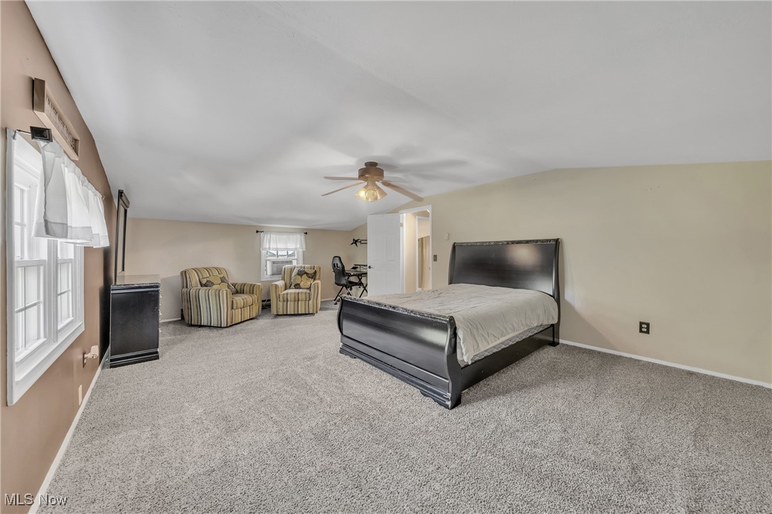 13510 Kinsman Road Burton, OH 44021 - Photo 26 of 40 Upstairs oversized bedroom with lofted ceiling, light carpet, and ceiling fan