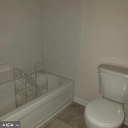 8405 Tee Road Lusby, MD 20657 - Photo 10 of 19 a white toilet sitting next to a shower