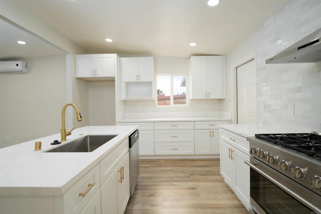 1314 Bluegrass Road Vista, CA 92083 - Photo 5 of 16 a kitchen with a sink stove top oven and cabinets