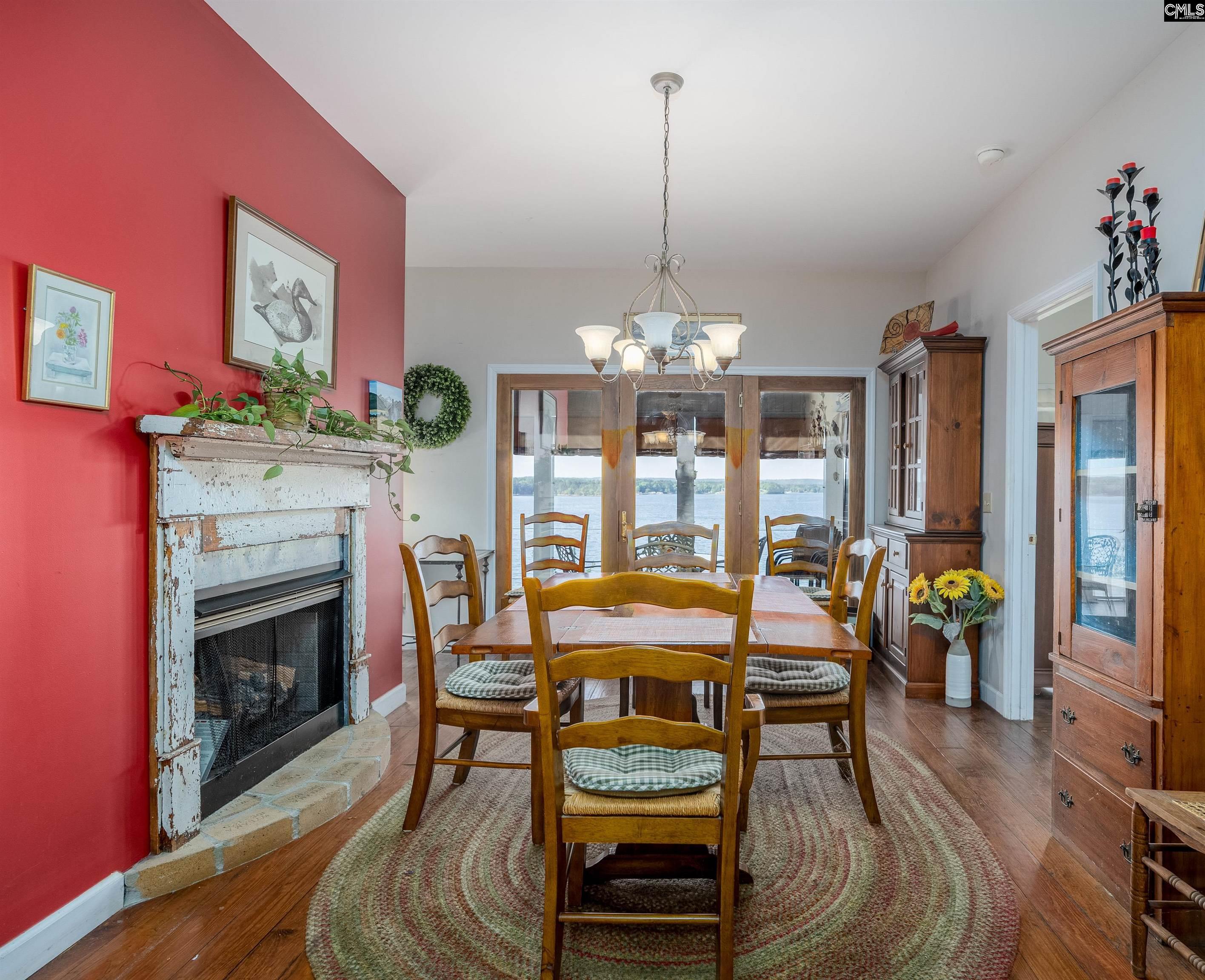 2577 Harbor View Road Camden, SC 29020 - Photo 16 of 42 a view of a dining room with furniture a chandelier and wooden floor