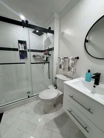 a bathroom with a sink toilet and shower