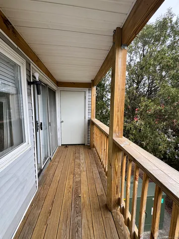 a view of deck with wooden floor and fence