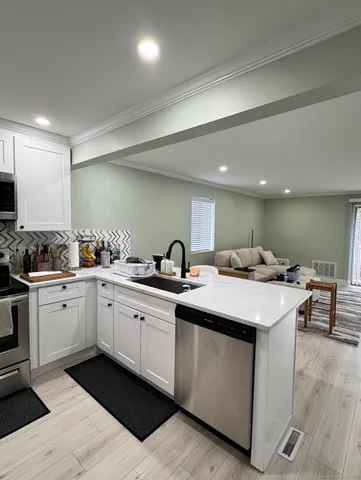 a kitchen with a sink and cabinets