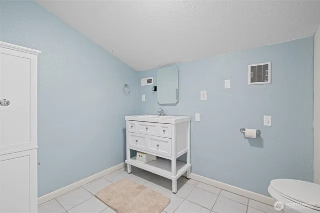 a bathroom with a bathtub sink and mirror
