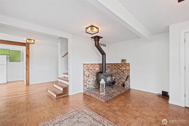 a kitchen with a sink cabinets and wooden floors