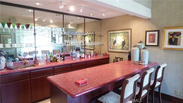 a room with stainless steel appliances dining table and chairs