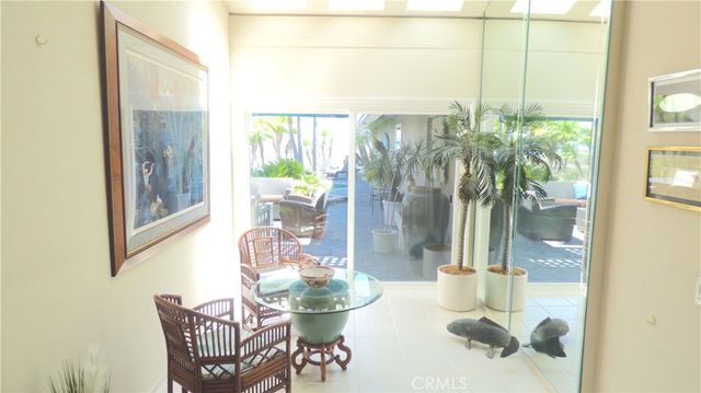 a dining room with furniture and a floor to ceiling window