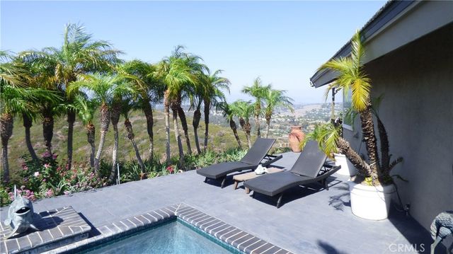 an aerial view of a house with outdoor space and trees