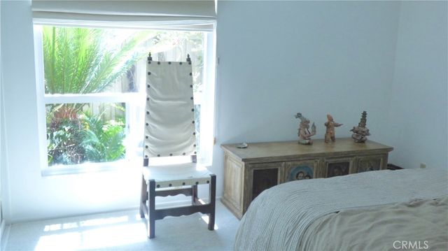 a bedroom with a bed and a chair