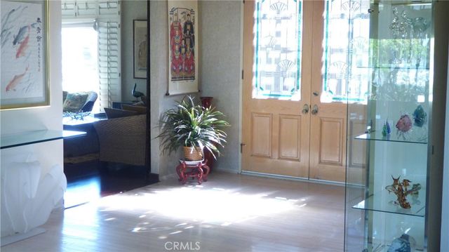 a view of hallway with furniture and a potted plant