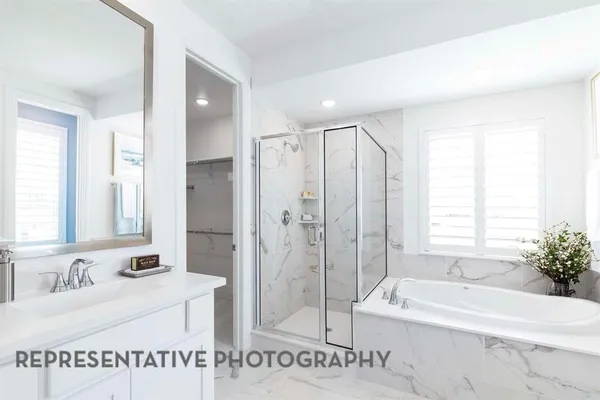 a spacious bathroom with a tub shower and a sink