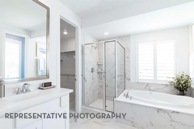 a spacious bathroom with a tub shower and a sink