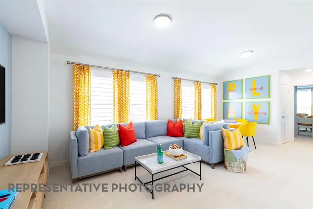 a living room with furniture and floor to ceiling windows