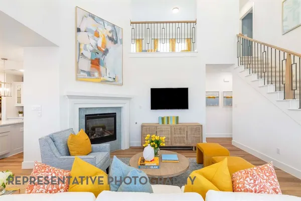 a living room with furniture a flat screen tv and a fireplace