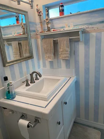 a bathroom with a sink and a mirror