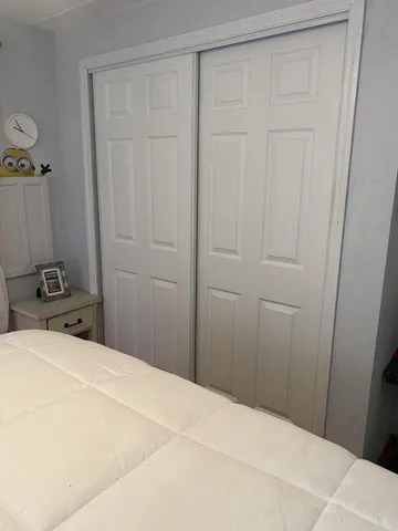 a bedroom with a bed and hallway