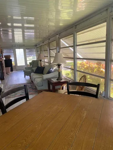 a living room with furniture and floor to ceiling window