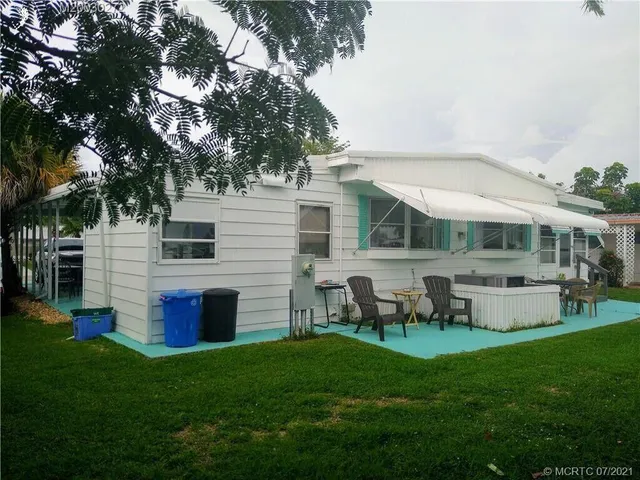 a front view of house with yard and outdoor seating