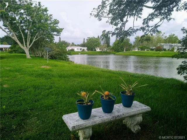 a view of a house with garden and lake view