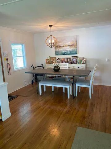 a living room with dining room and wooden floor