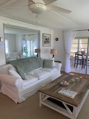 a living room with furniture and chandelier