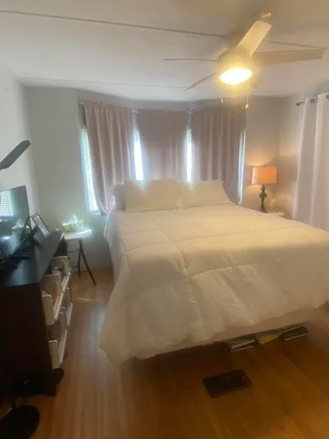 a bedroom with a bed and a lamp