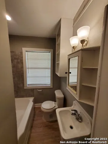 a white toilet sitting next to a bathroom sink