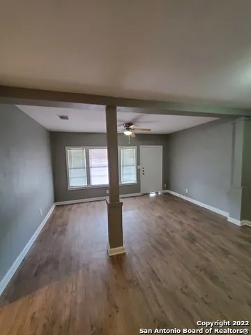 wooden floor in an empty room with a window