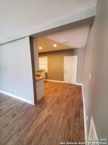 a view of a kitchen with wooden floor
