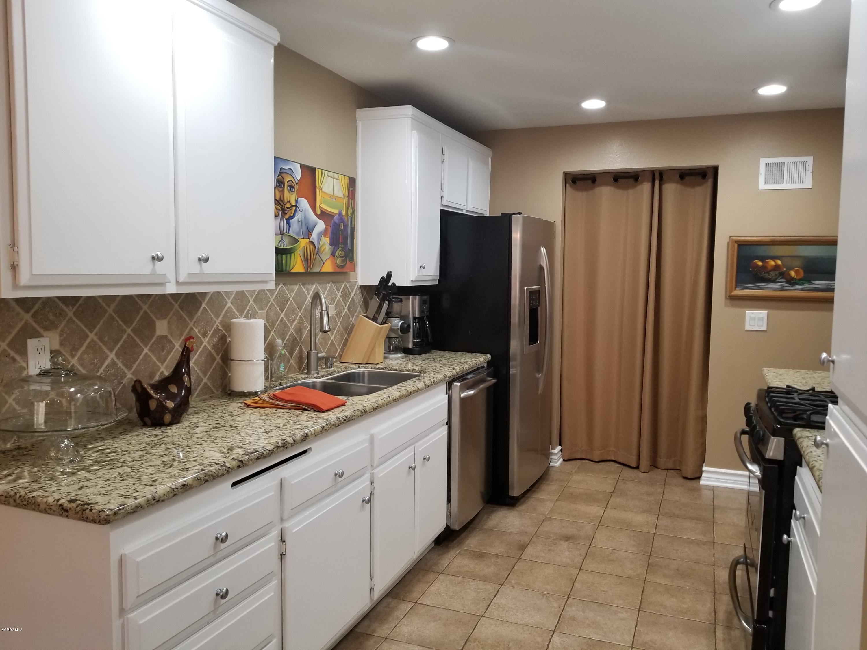 5727 Cochran Street Simi Valley, CA 93063 - Photo 17 of 43 a kitchen with stainless steel appliances granite countertop a refrigerator and a stove