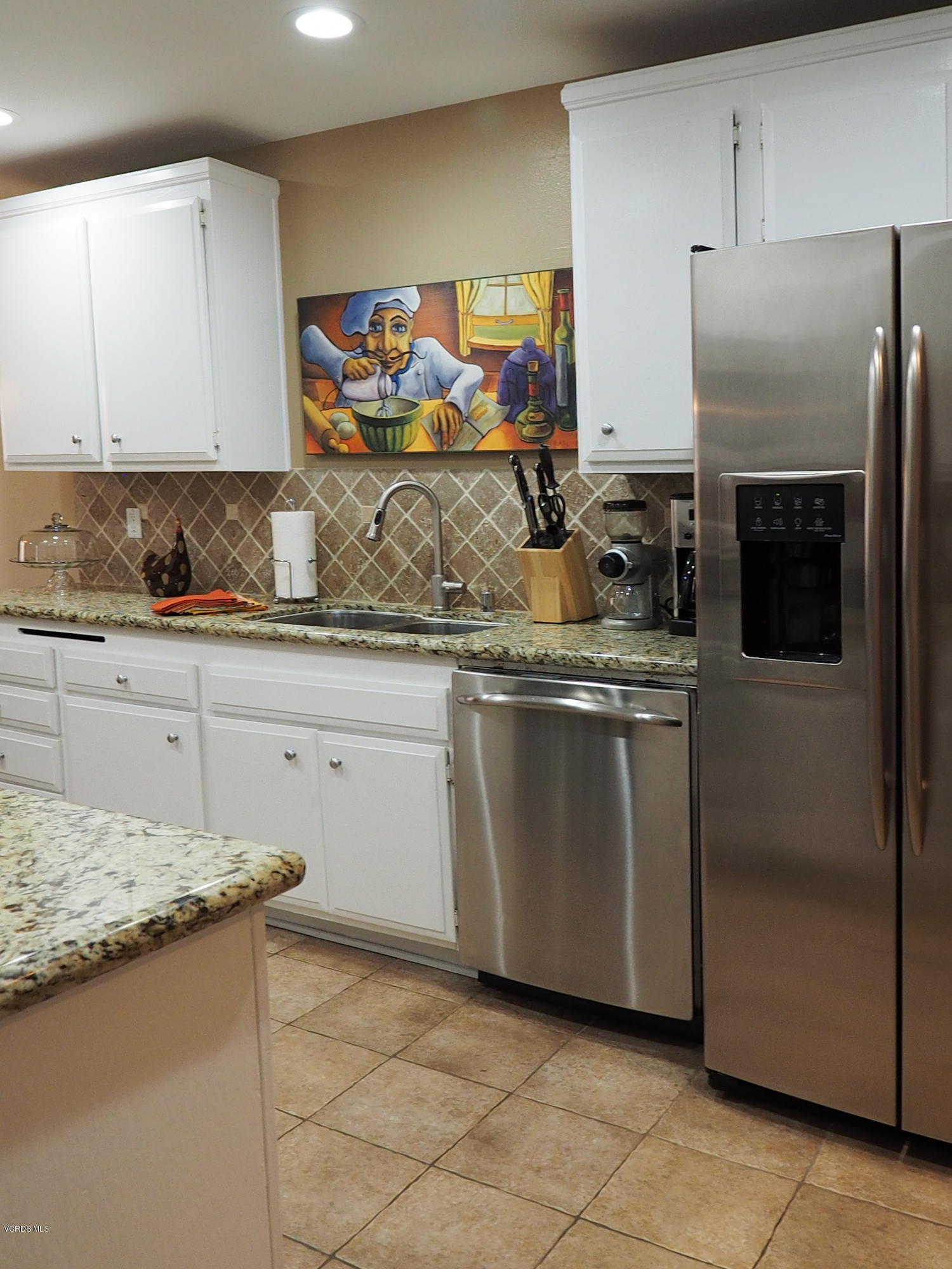 5727 Cochran Street Simi Valley, CA 93063 - Photo 19 of 43 a kitchen with stainless steel appliances granite countertop a stove a sink and a refrigerator