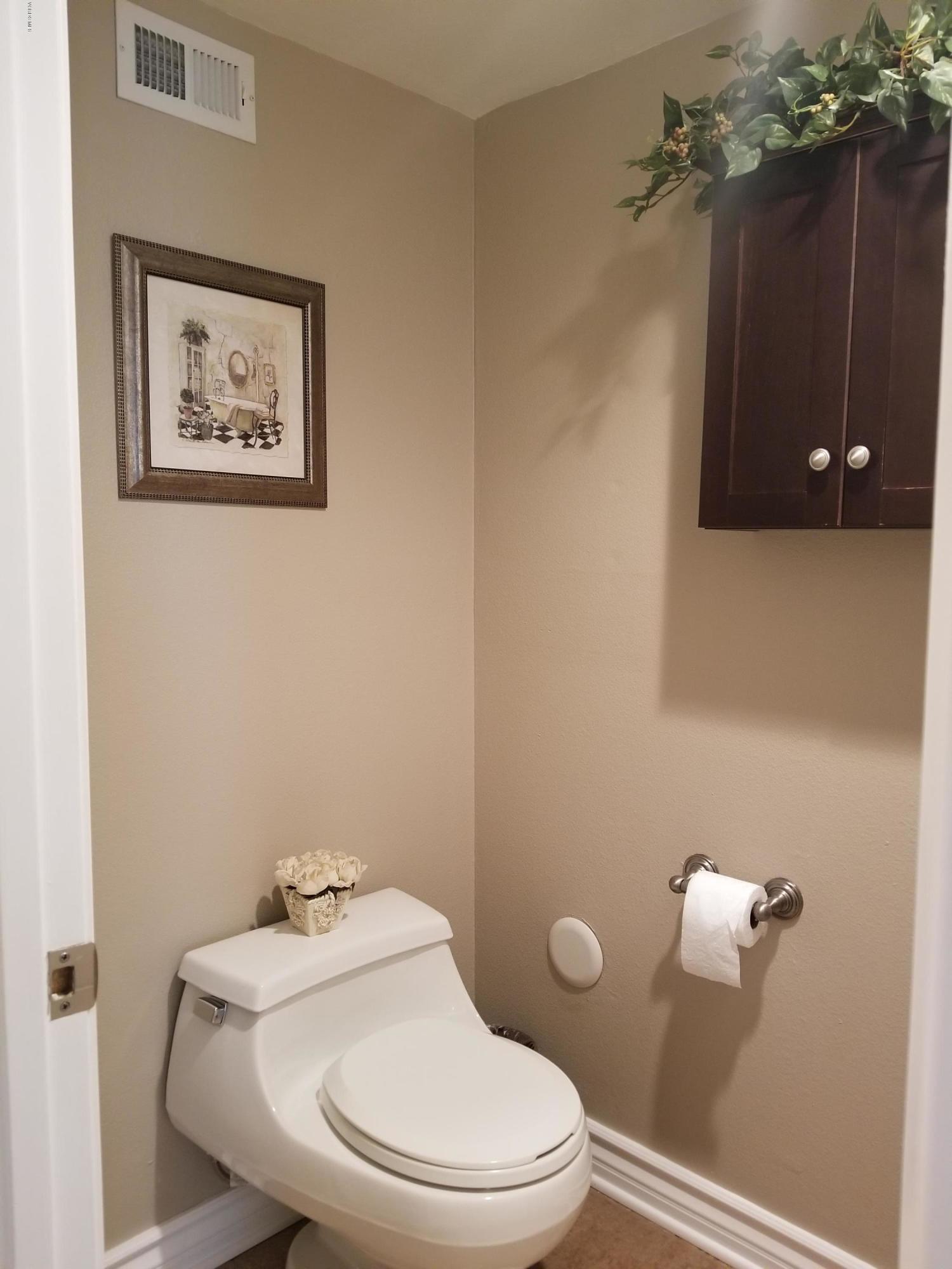 5727 Cochran Street Simi Valley, CA 93063 - Photo 21 of 43 a white toilet sitting next to a bathroom sink and vanity