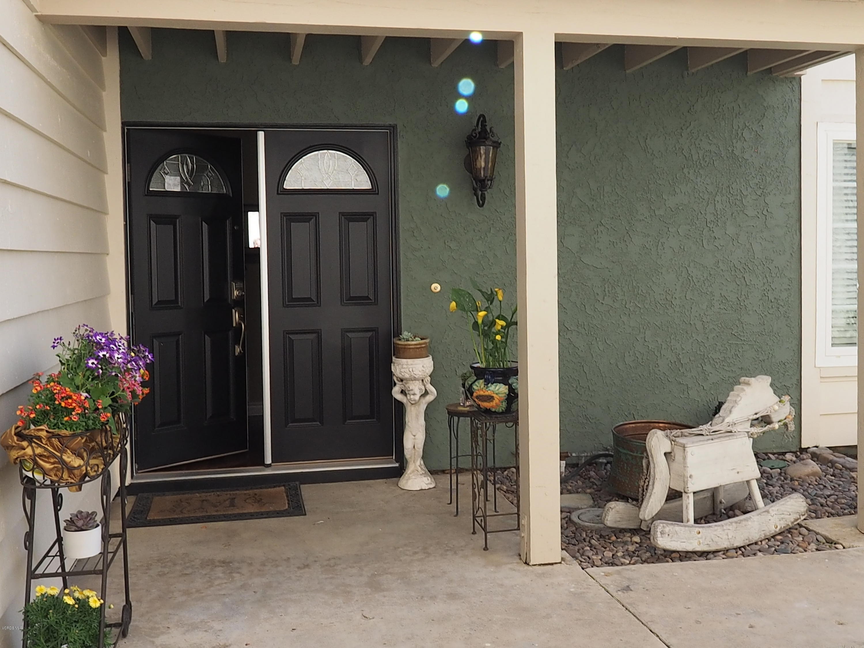 5727 Cochran Street Simi Valley, CA 93063 - Photo 10 of 43 a front view of a house with outdoor seating and flowers