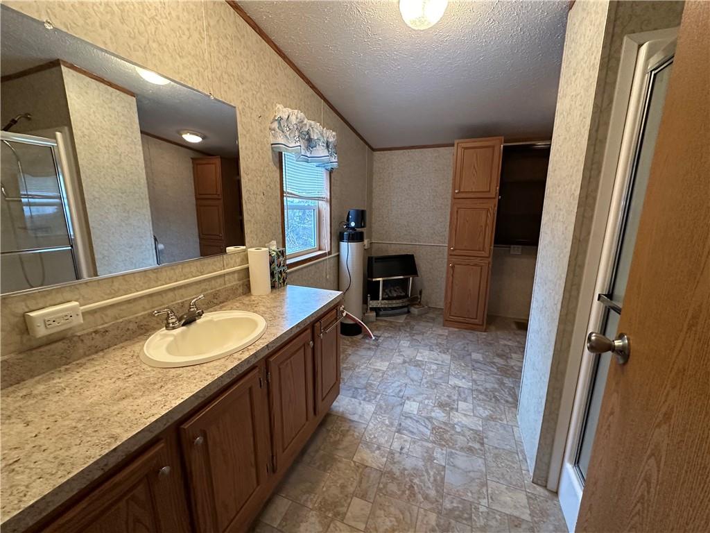 107 Trieste Street Butler, PA 16002 - Photo 21 of 40 a spacious bathroom with a granite countertop sink a mirror and a shower