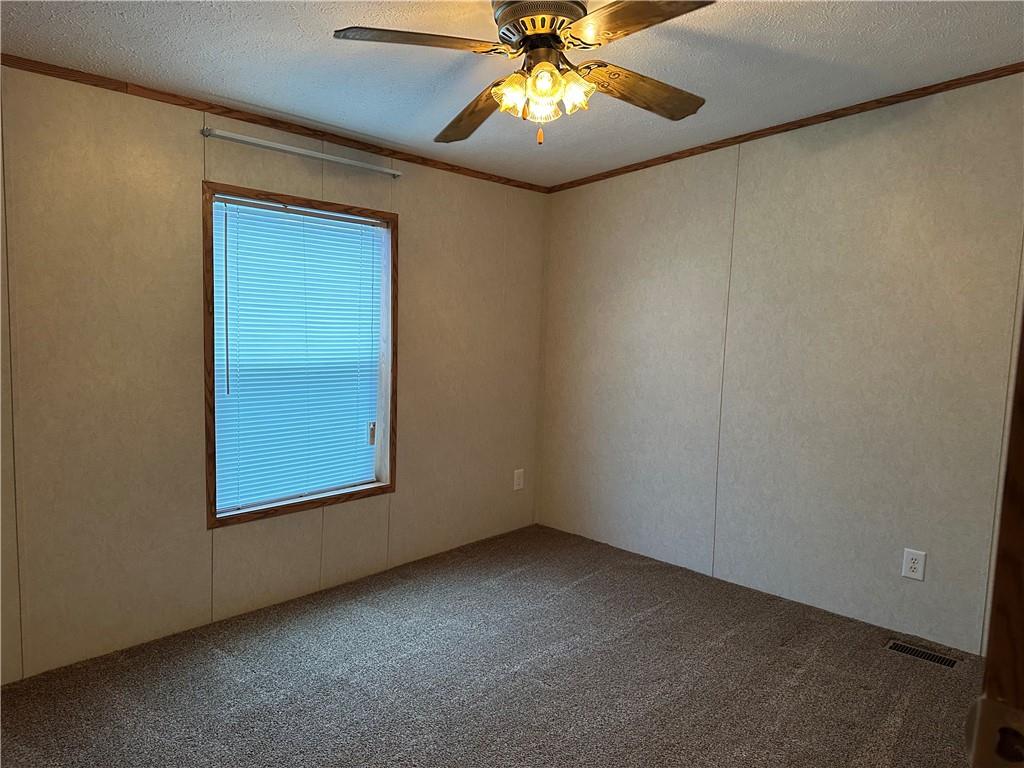 107 Trieste Street Butler, PA 16002 - Photo 24 of 40 an empty room with a chandelier fan and windows